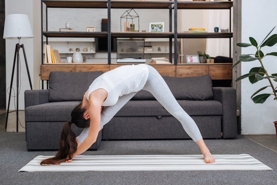 Woman stretching in a living room.