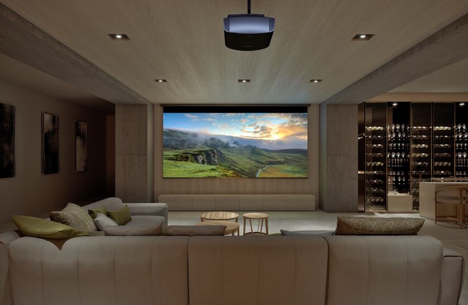 a home theater with a sectional facing a large screen on the wall