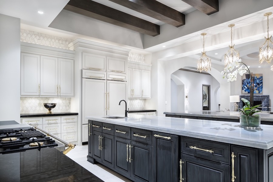 Ketra lighting elevates a white and black kitchen with varied levels of brightness.